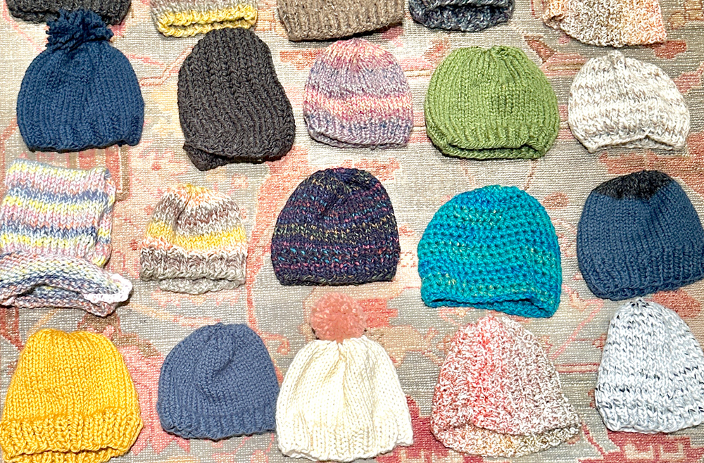 Rows of colorful winter hats on the floor